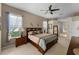 Well-lit primary bedroom featuring carpet, ceiling fan, and natural light at 821 Shallow Brook Ave, Winter Springs, FL 32708