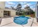 Screened-in pool area with an in-ground pool, white tiling and a covered patio that is perfect for outdoor relaxation at 821 Shallow Brook Ave, Winter Springs, FL 32708