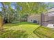 Beautiful backyard with healthy green lawn, mature trees, and a screened-in patio at 828 Timber Court Ct, Apopka, FL 32712
