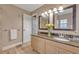 Bathroom featuring granite countertop, wood cabinets, and framed mirrors at 828 Timber Court Ct, Apopka, FL 32712