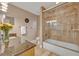 Bathroom featuring granite countertop, bathtub, and tiled shower with glass enclosure at 828 Timber Court Ct, Apopka, FL 32712