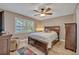 Bedroom featuring ceiling fan, window with shutters, and neutral color palette at 828 Timber Court Ct, Apopka, FL 32712