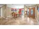 Elegant dining room with a wooden table set, neutral walls, and decorative wall art and front door at 828 Timber Court Ct, Apopka, FL 32712
