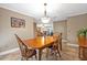Charming dining room features a wooden table, neutral paint and a view of other living spaces at 828 Timber Court Ct, Apopka, FL 32712