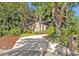 Long driveway leading to a brick home surrounded by mature trees at 828 Timber Court Ct, Apopka, FL 32712