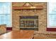 Brick fireplace with wooden mantel and glass doors at 828 Timber Court Ct, Apopka, FL 32712