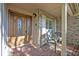 Inviting front porch with brick accents, a decorative door and chairs at 828 Timber Court Ct, Apopka, FL 32712