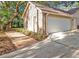 Spacious two-car garage with a brick pathway to the home at 828 Timber Court Ct, Apopka, FL 32712