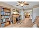 Well-appointed home office with a rolltop desk, bookshelf, and a comfortable sitting area at 828 Timber Court Ct, Apopka, FL 32712