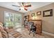 Functional home office featuring a traditional rolltop desk, built-in bookcase, and plantation shutters at 828 Timber Court Ct, Apopka, FL 32712