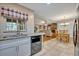 Open concept kitchen with stainless steel dishwasher flows into the dining and living area at 828 Timber Court Ct, Apopka, FL 32712