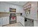 Updated kitchen features white cabinets, granite countertops, and stainless steel appliances at 828 Timber Court Ct, Apopka, FL 32712