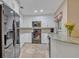 Modern kitchen with stainless steel appliances, white cabinetry, granite countertops, and ample storage space at 828 Timber Court Ct, Apopka, FL 32712