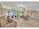 Inviting living room featuring tile flooring, a ceiling fan, comfortable seating and view to outdoor patio at 828 Timber Court Ct, Apopka, FL 32712