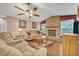 Living room featuring a brick fireplace, wood floors, and neutral-toned furniture at 828 Timber Court Ct, Apopka, FL 32712