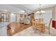 Open floor plan with dining and living room featuring wood floors and a brick fireplace at 828 Timber Court Ct, Apopka, FL 32712