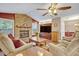 Living room featuring a brick fireplace, wood floors, and a ceiling fan at 828 Timber Court Ct, Apopka, FL 32712