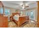 Spacious main bedroom features hardwood floors, ceiling fan, and french doors to lanai at 828 Timber Court Ct, Apopka, FL 32712