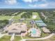 Beautiful aerial view showcases the community clubhouse, pool, tennis courts, and golf course at 8430 Woburn Ct, Windermere, FL 34786