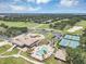 Birds eye view of the clubhouse, pool, and tennis courts within a lush, well-manicured community at 8430 Woburn Ct, Windermere, FL 34786
