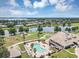 A picturesque aerial view of the community clubhouse and pool area, nestled by a tranquil pond at 8430 Woburn Ct, Windermere, FL 34786
