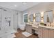 This bathroom showcases a glass shower, soaking tub, dual sinks, and stylish fixtures at 8430 Woburn Ct, Windermere, FL 34786