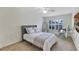 Bright bedroom with carpet, window shutters, a desk and a comfortable bed at 8430 Woburn Ct, Windermere, FL 34786