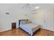 Cozy bedroom with wood floors, comfortable bed and a mini split air conditioner at 8430 Woburn Ct, Windermere, FL 34786