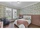 Charming bedroom with decorative wallpaper, wood floors, and lots of natural light at 8430 Woburn Ct, Windermere, FL 34786