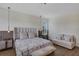 This bedroom features a luxurious upholstered headboard and seating area offering comfort and style at 8430 Woburn Ct, Windermere, FL 34786