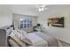 Bright bedroom with carpet, window shutters, a desk, comfortable bed and television at 8430 Woburn Ct, Windermere, FL 34786