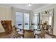 Dining room with a glass table, tile flooring, and modern chairs at 8430 Woburn Ct, Windermere, FL 34786