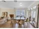 Bright dining room featuring a modern glass table, seating for six, and large mirror at 8430 Woburn Ct, Windermere, FL 34786