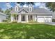 Charming home boasts a manicured lawn, columns, and a two-car garage at 8430 Woburn Ct, Windermere, FL 34786