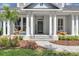 Inviting front porch with stone steps and beautiful landscaping at 8430 Woburn Ct, Windermere, FL 34786
