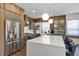 Modern kitchen featuring stainless steel appliances, a large island, and stylish lighting at 8430 Woburn Ct, Windermere, FL 34786
