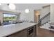 Open-concept living space with modern kitchen island overlooking lake views at 8430 Woburn Ct, Windermere, FL 34786