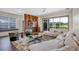 Open-concept living room with abundant natural light and views of the backyard at 8430 Woburn Ct, Windermere, FL 34786