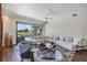 Spacious living room featuring large sliding glass doors leading to an outdoor pool area at 8430 Woburn Ct, Windermere, FL 34786