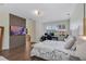 The bright main bedroom boasts an ensuite bath, desk area, TV wall, and shuttered windows at 8430 Woburn Ct, Windermere, FL 34786