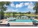 Beautiful pool and spa with lake view and a landscaped fence at 8430 Woburn Ct, Windermere, FL 34786