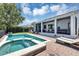 Backyard oasis featuring a private pool, spa, covered patio, and lush landscaping at 8430 Woburn Ct, Windermere, FL 34786