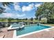 Serene backyard pool with spa and view of the lake at 8430 Woburn Ct, Windermere, FL 34786