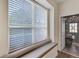 Charming window seat offers a cozy spot with a view, adjacent to a doorway with patterned wallpaper at 8430 Woburn Ct, Windermere, FL 34786