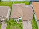 An aerial view showcasing a meticulously landscaped home with a tile roof, a driveway, and lush green surroundings at 8491 Pippen Dr, Orlando, FL 32836