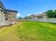 A spacious backyard featuring a green lawn, a covered patio, and perimeter fencing for privacy and outdoor enjoyment at 8491 Pippen Dr, Orlando, FL 32836
