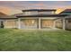 A spacious backyard with green lawn and covered patio, offering an ideal outdoor living and entertaining space at 8491 Pippen Dr, Orlando, FL 32836
