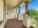 Spacious outdoor balcony, covered with pillars and landscaping in the background at 8491 Pippen Dr, Orlando, FL 32836
