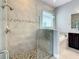 Bathroom featuring glass-enclosed shower, soaking tub, and a vanity with dark wood cabinets at 8491 Pippen Dr, Orlando, FL 32836