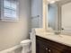 Bathroom features a dark cabinet vanity with light countertop and bright lighting at 8491 Pippen Dr, Orlando, FL 32836